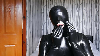 Latex-Clad Bondage Slave In Gas Mask And Gag